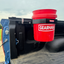 Red 'Gearhaul' bucket attached to a Toyota open tailgate