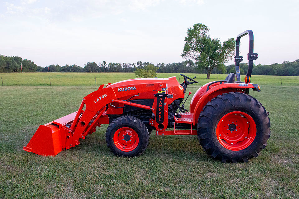 Orange Kubota Tractor with SawHaul Complete Kit for Tractors mounted to the tractor's loader arm