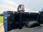Sawhaul tool holder mounted on a truck bed with a power tool attached.