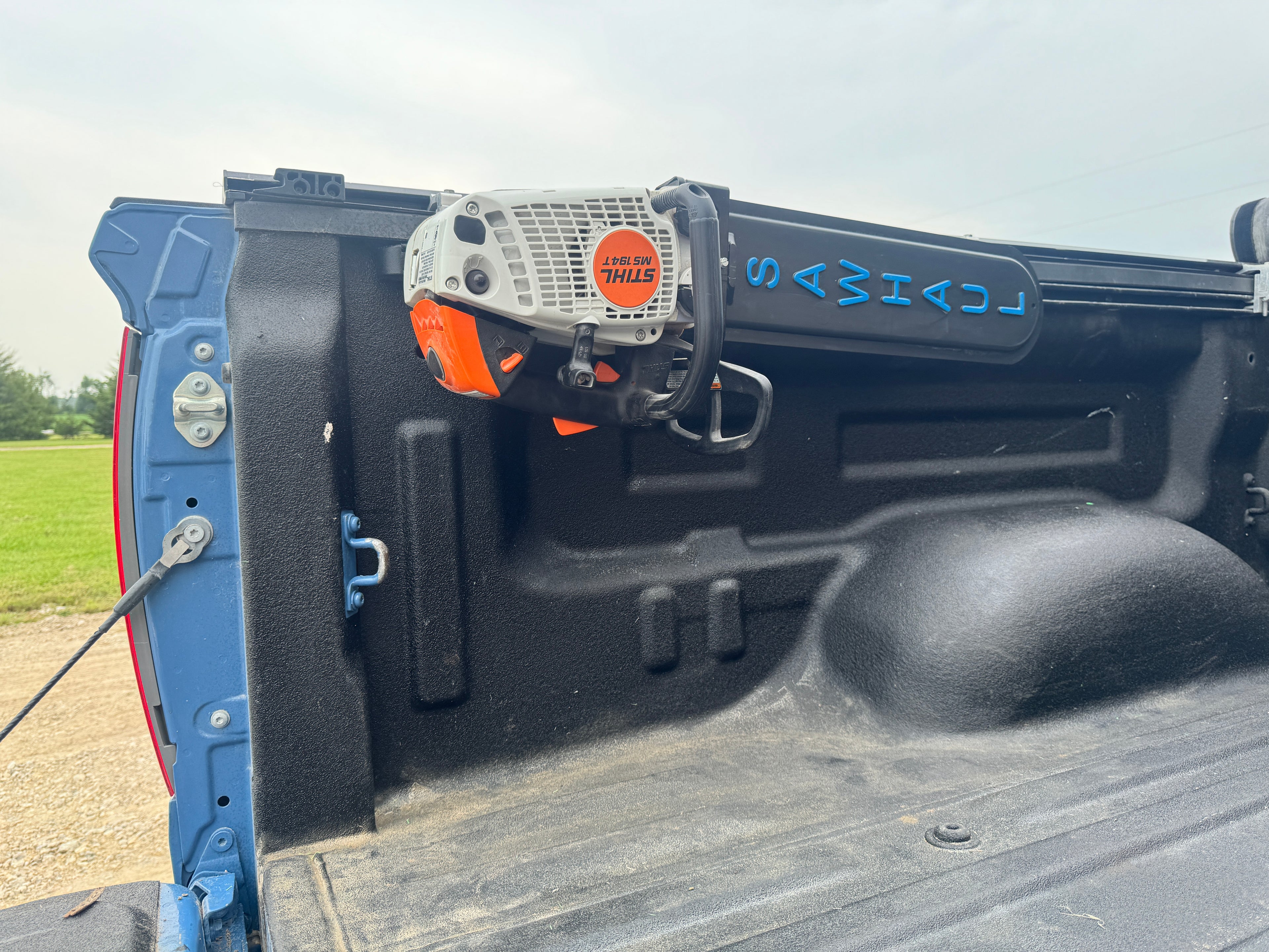 CHAINSAW IN A SAWHAUL ON THE BED OF A TOYOTA TRUCK