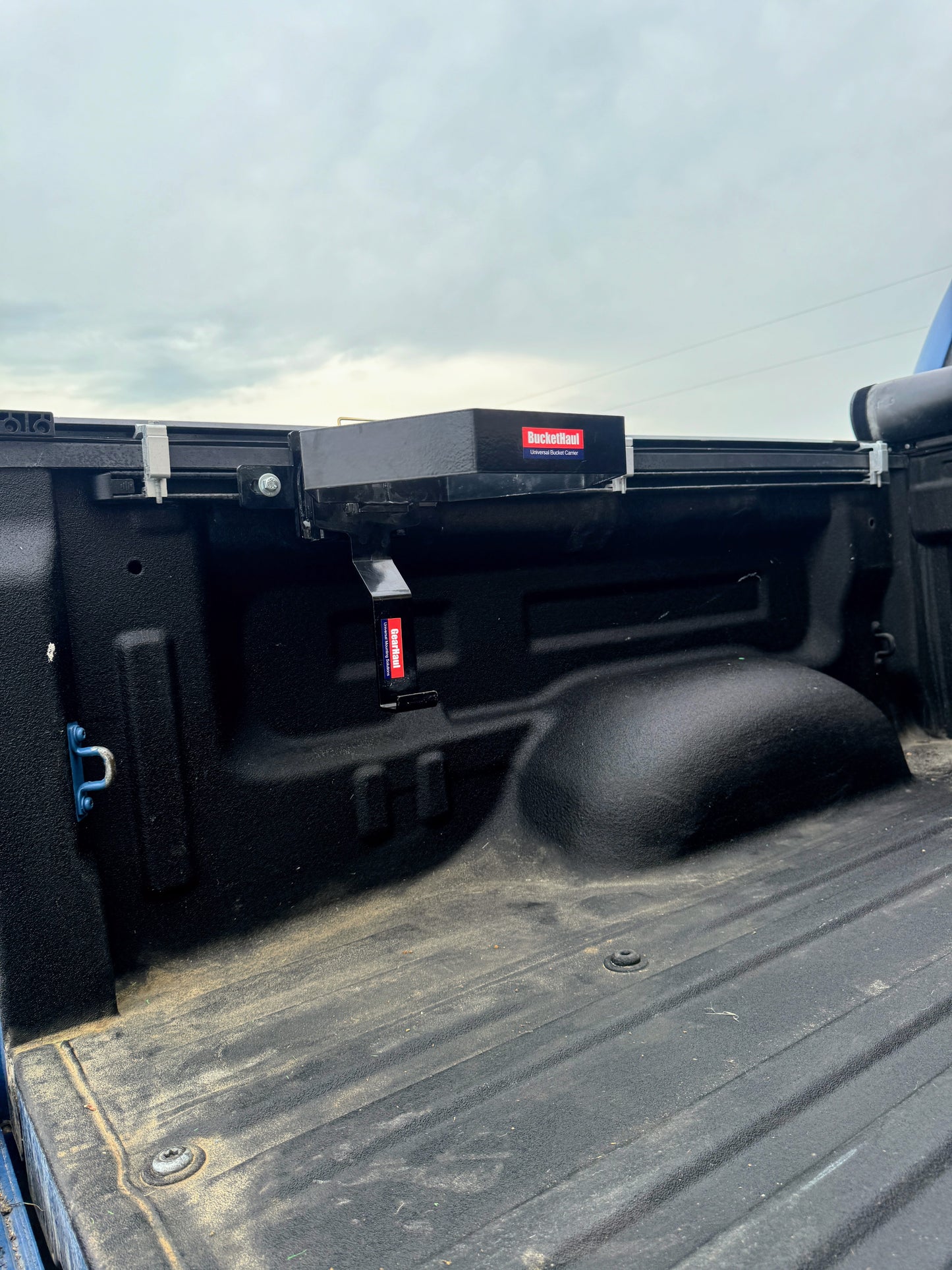 Open truck bed with buckethaul on a cloudy day.